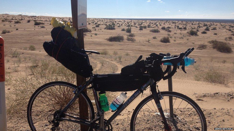 James' bike propped up in a desert scene