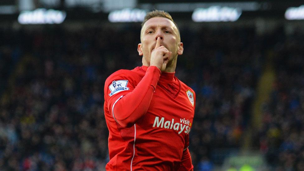 Craig Bellamy asks the crowd to be quiet after scoring against Norwich