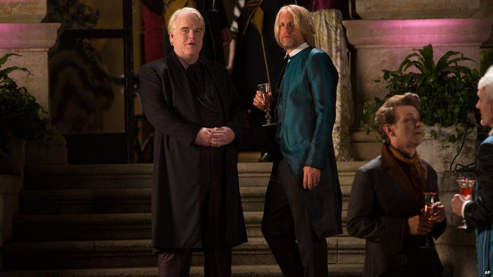 Philip Seymour Hoffman as Plutarch Heavensbee, left, and Woody Harrelson as Haymitch Abernathy in a scene from "The Hunger Games: Catching Fire."