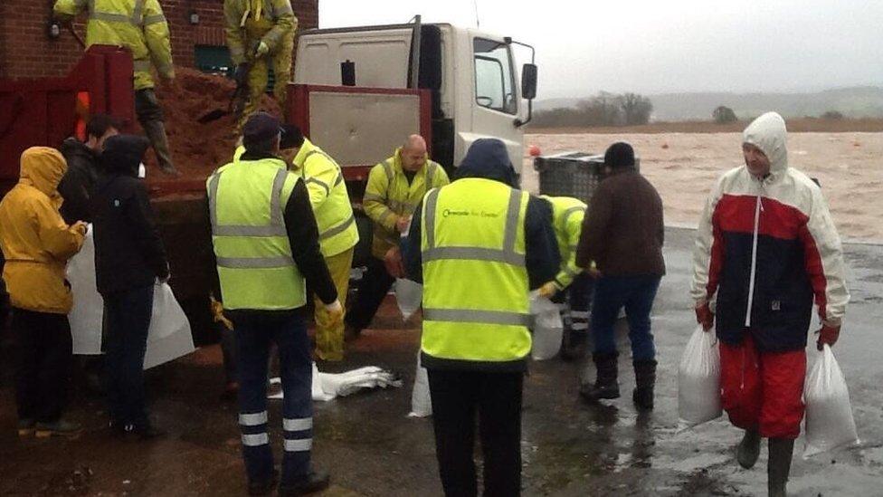 Residents being handed sandbags in Topsham, near Exeter, in Devon