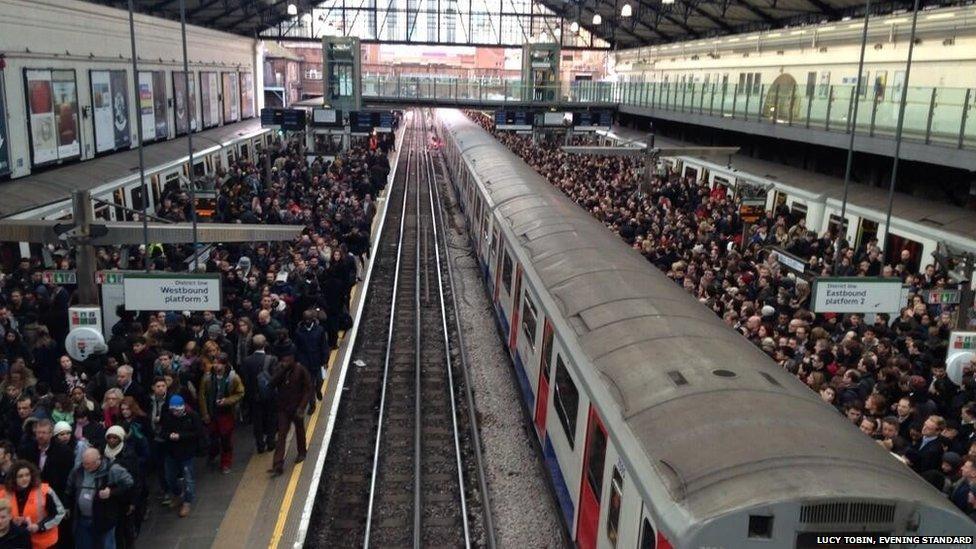 Hundreds of commuters queue for the tube at Earl's Court