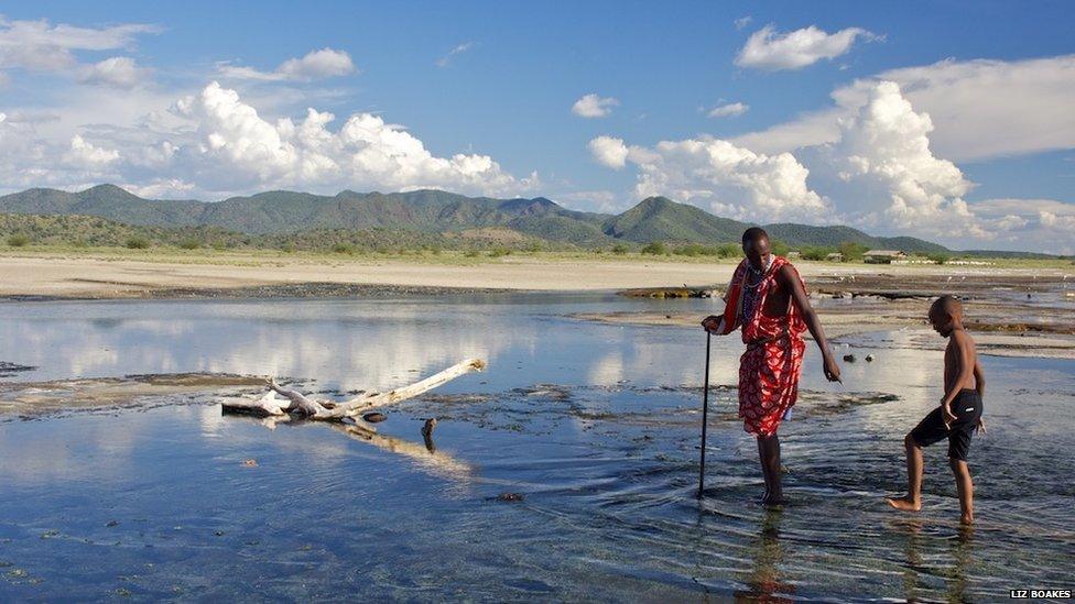 Maasai helping a young boy in Kenya