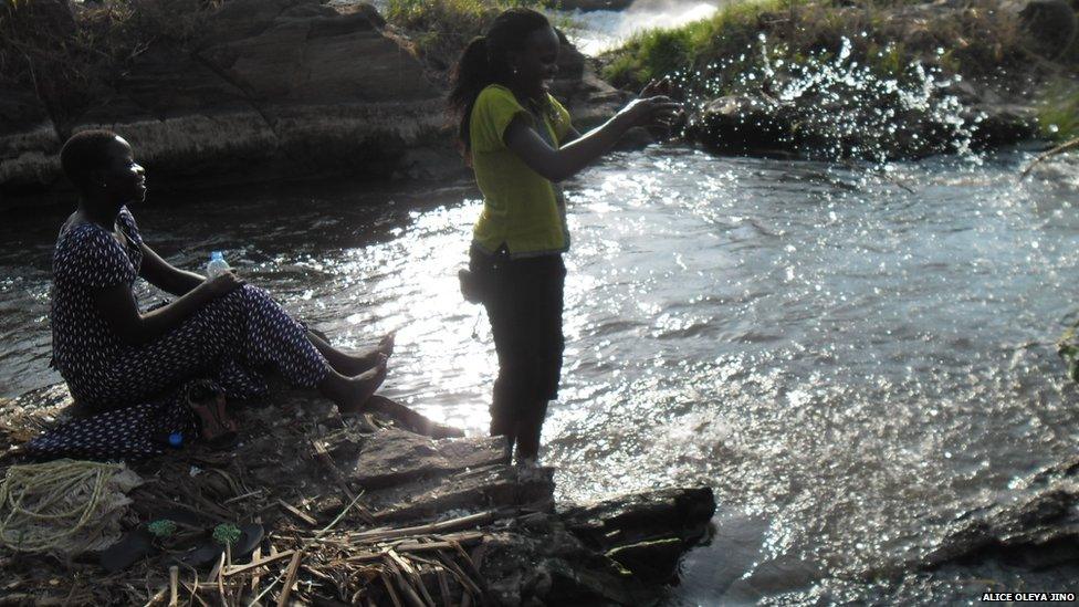 Alice Oleya Jino and friend splashing in the Fulla Falls in South Sudan