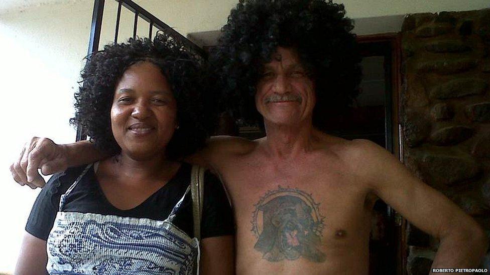 Wig-wearing man together with his housekeeper in South Africa