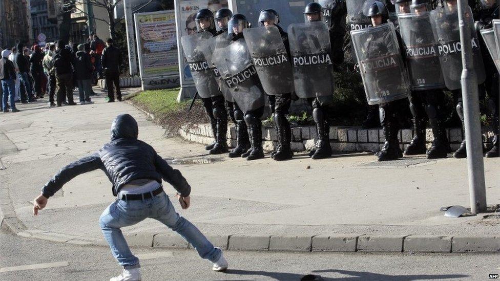 Protester in front of riot police in Sarajevo (7 February 2014)