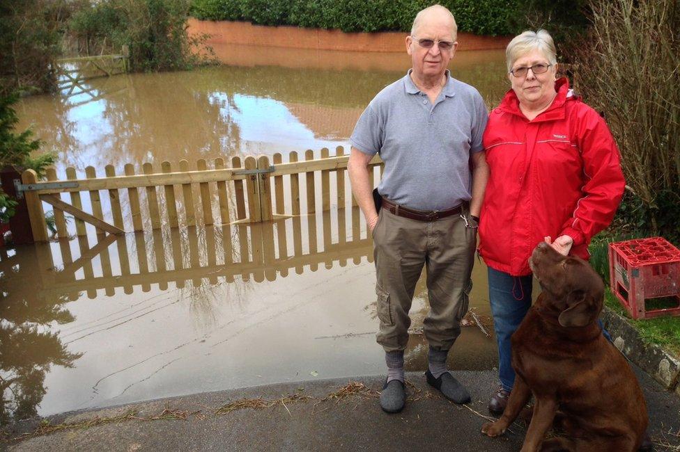 Jennifer and Hywel Jones in front of floodwaters near their house in East Lyng, Somerset