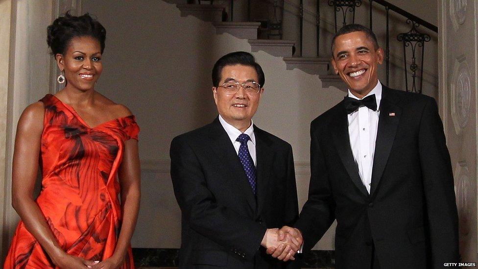 President Barack Obama and Chinese President Hu Jintao shake hands and pose with First Lady Michelle Obama outside the White House on 19 January 2011