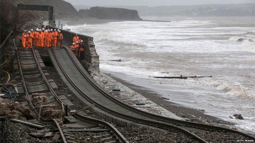 Railway workers inspect the main Exeter to Plymouth railway line that has been closed due to parts of it being washed away by the sea at Dawlish