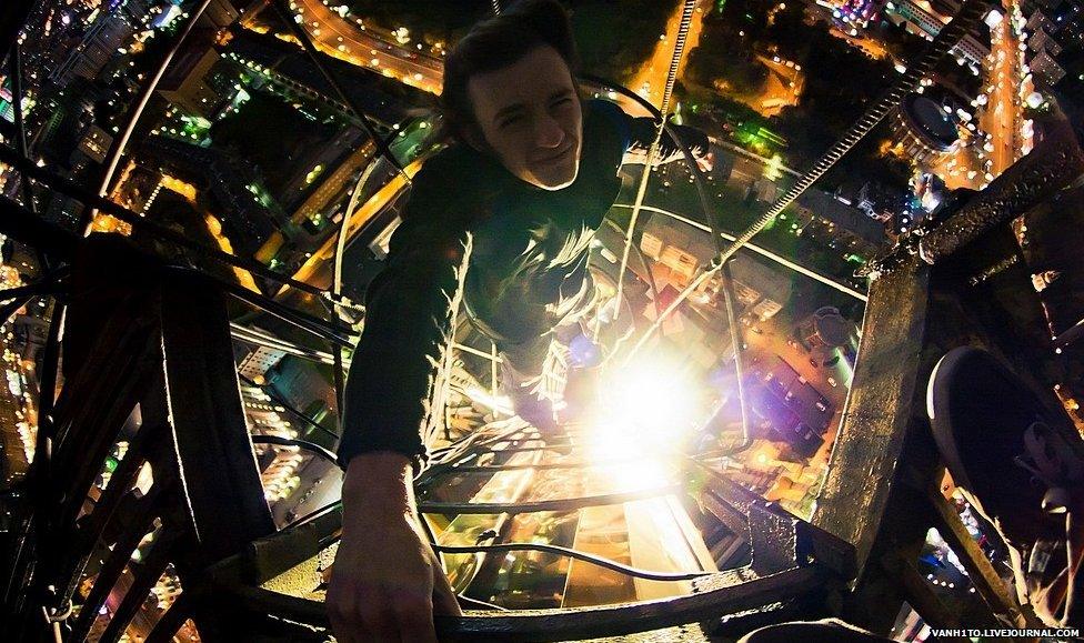 Climber illuminated by light from below