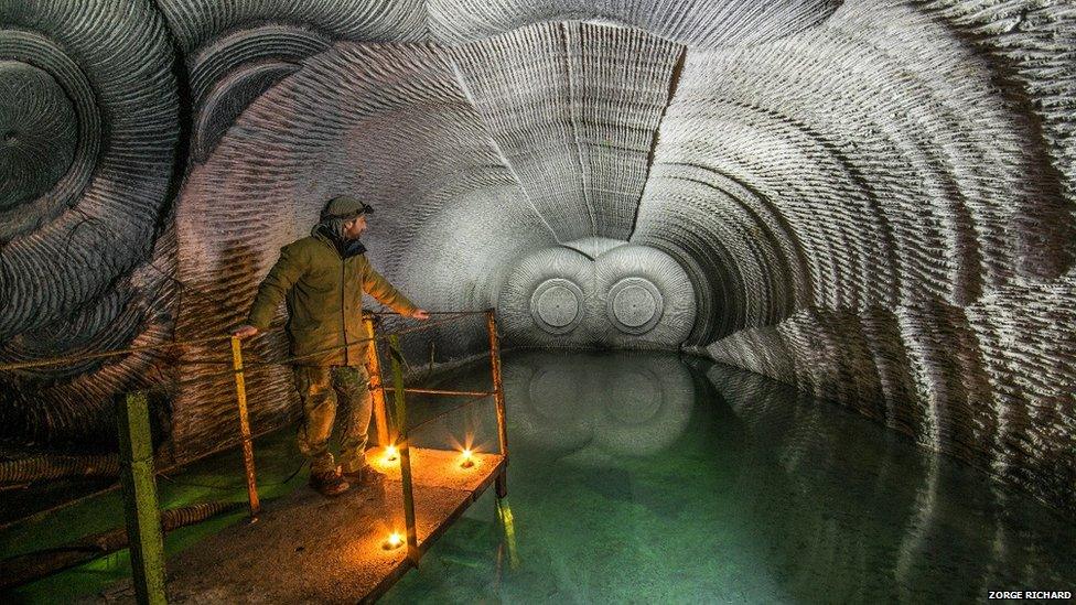 A man stood in an unusual looking cave