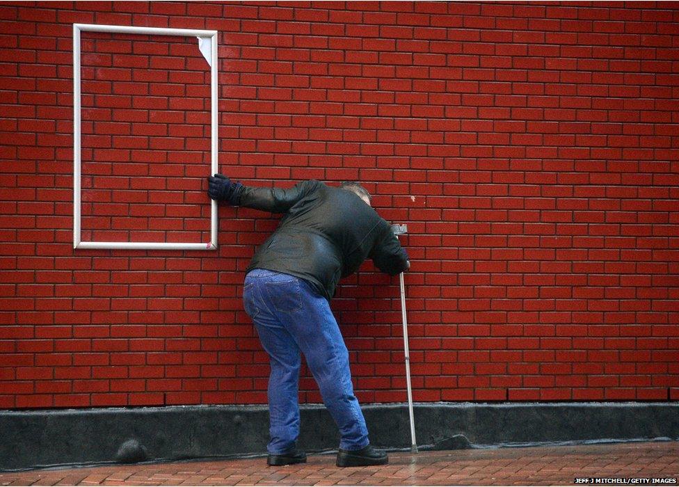 A man struggles in the high winds at Blackpool promenade