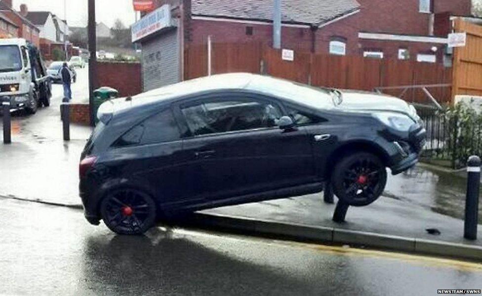 A car crashes onto bollards in the treacherous weather conditions on the City Road in Tividale, West Midlands