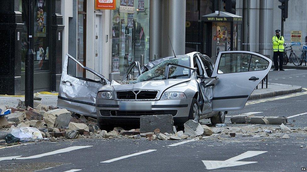 The scene in Kingsway opposite Holborn Tube station in central London, after a woman was killed after large chunks of masonry fell on to a Skoda Octavia vehicle she was in at 11.05pm yesterday.