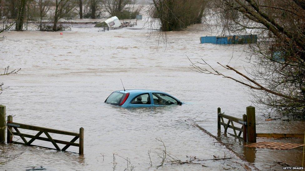 A car sits in flood water