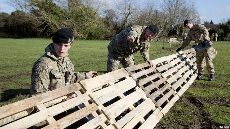 Members of the 2nd Royal Tank Regiment build flood defences in Staines