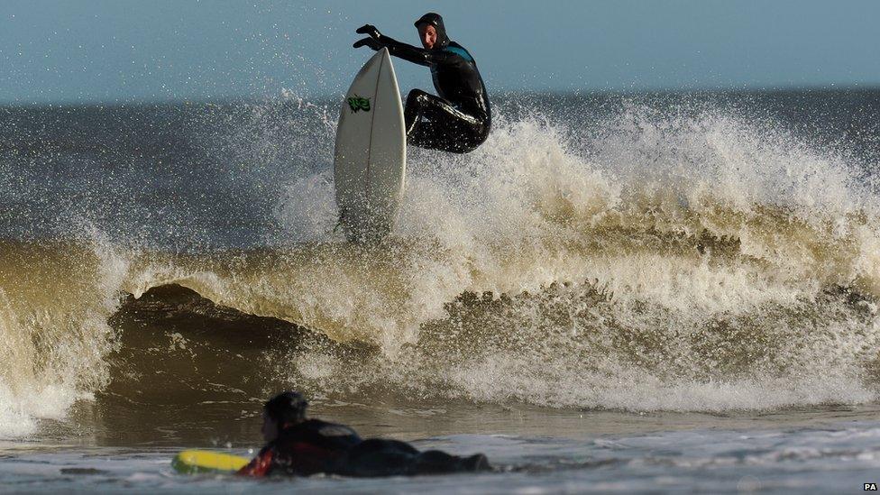 A surfer rides the waves at Tynemouth, Tyne and Wear,