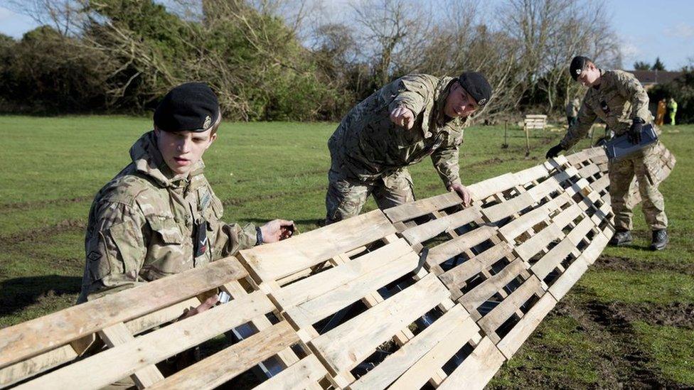 Members of the 2nd Royal Tank Regiment build flood defences in Staines