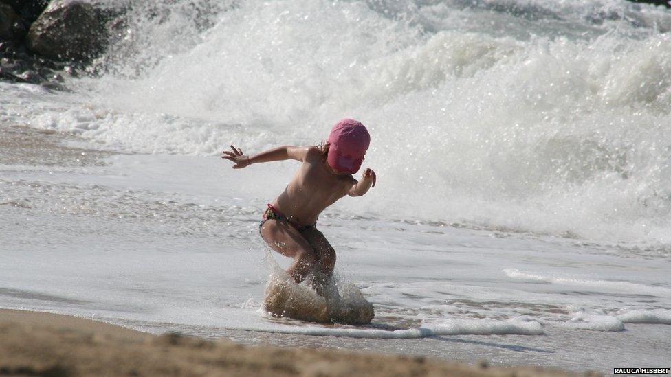 Waves and young girl surfing