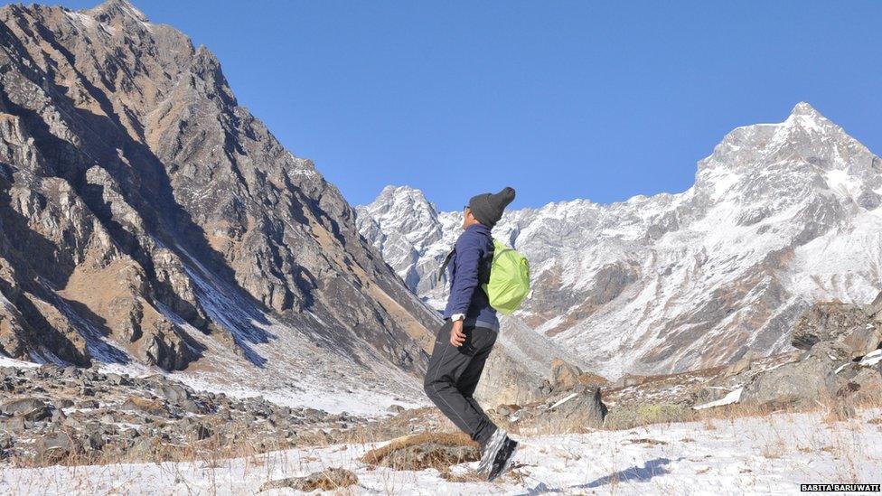 Babita Baruwati standing among the mountains in Hatta Valley, Uttrakhand, India