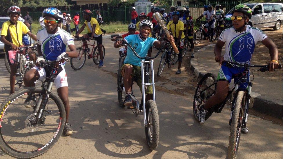 Cyclists take the baton on a trip towards the Royal Palace in Maseru, Lesotho.