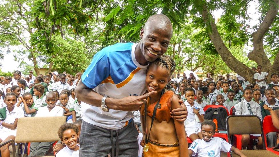 Olympic silver medallist Nijel Amos joins the baton celebrations with pupils from Tlokweng Junior School in Gaborone, Botswana,