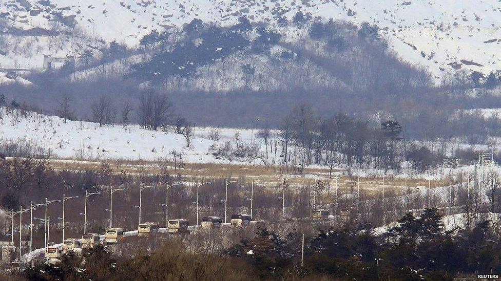 South Korean buses transporting participants of the family reunion cross the border line as they leaves for Mount Kumgang resort in North Korea at Goseong, about 200 km (124 miles) northeast of Seoul on 20 February 2014