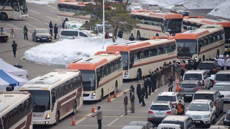 Buses carrying attendees of a family reunion between North and South Korea leave the hotel in the eastern port city of Sokcho on 20 February 2014