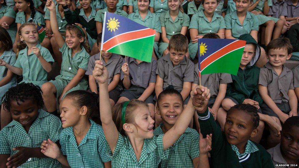 Children from Pioneers Park Primary School in Windhoek, Namibia cheer wildly for the arrival of the Queen's baton.