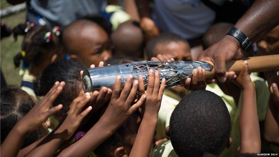 Primary school children touch the baton on the island of Rodrigues, Mauritius.