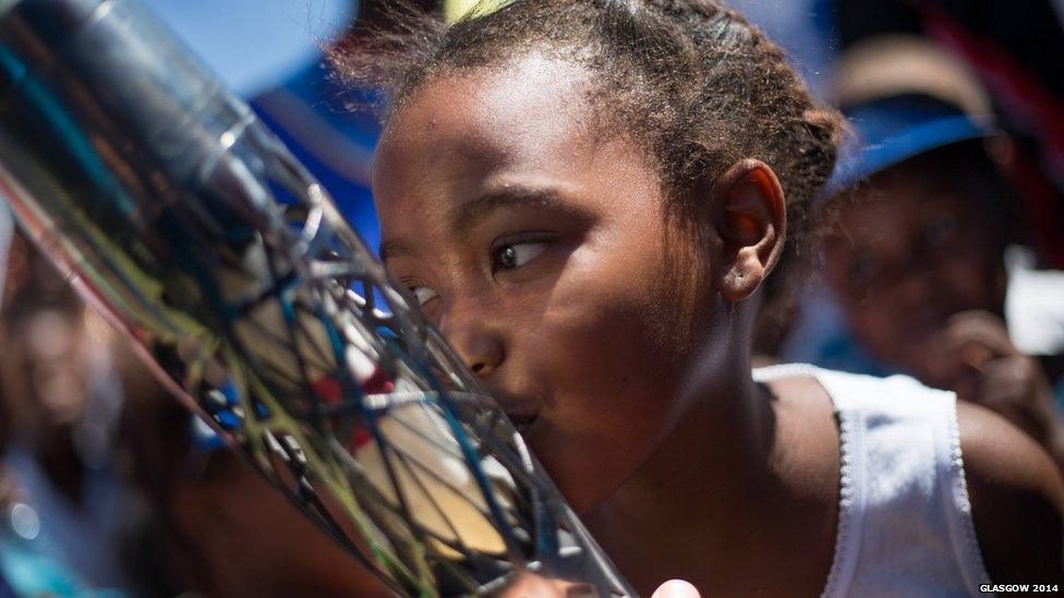 A young girl kisses the baton as the journey prepare to depart South Africa.