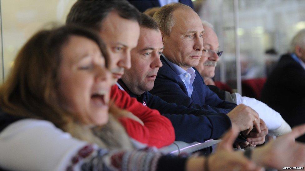 Slovakia's President Ivan Gasparovic, Russia's President Vladimir Putin, Prime Minister Dmitry Medvedev, Deputy Prime Minister Arkady Dvorkovich and Medvedev's press secretary Natalya Timakova watch the Men's Ice Hockey Group A match between Russia and Slovakia at the Bolshoy Ice Dome in Sochi during the Sochi Winter Olympics on February 16, 2014.