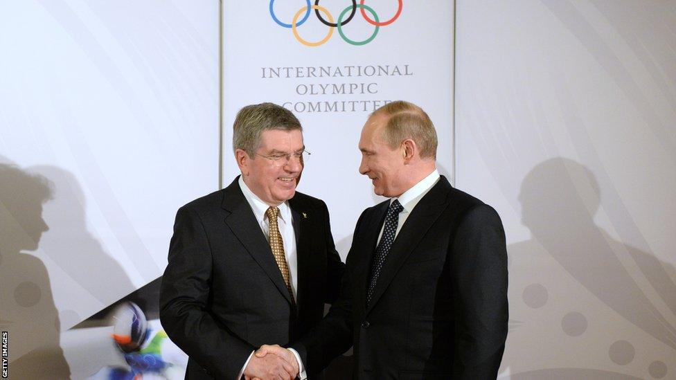 SOCHI, RUSSIA - FEBRUARY 06: President of the International Olympic Committee (IOC), Thomas Bach (L) shakes hands with Russian President Vladimir Putin before the IOC Gala Dinner on the eve of the Sochi 2014 Winter Olympics on February 6, 2014 in Sochi, Russia.