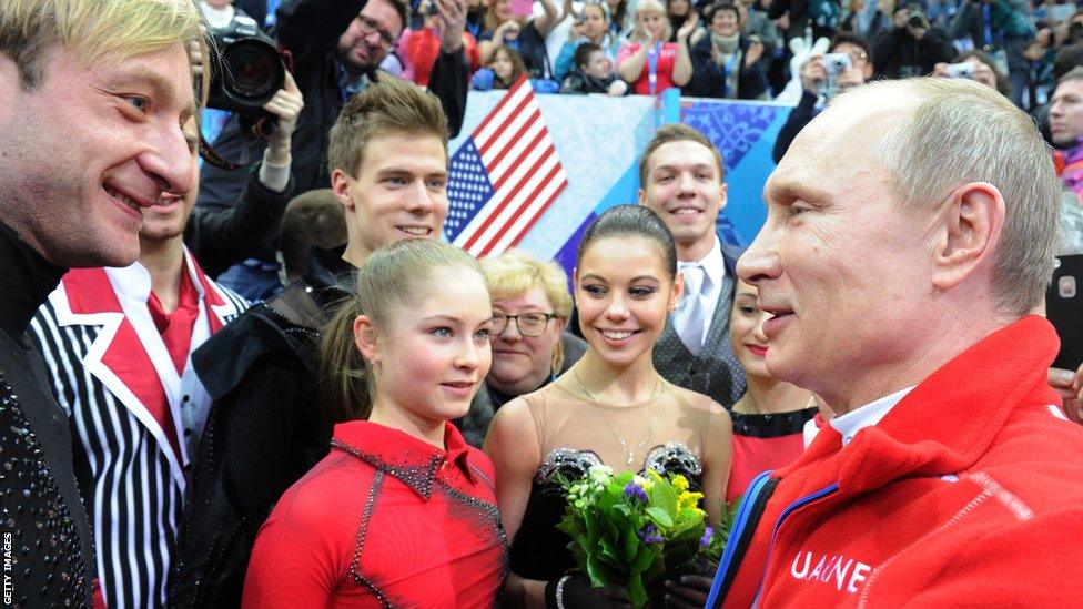 Russia's President Vladimir Putin (R) speaks with Evgeni Plushenko (L), Yulia Lipnitskaia (2nd L) and other Russian figure skaters after watching the Women's Figure Skating Team Free Program at the Iceberg Skating Palace during the Sochi Winter Olympics on February 9, 2014.