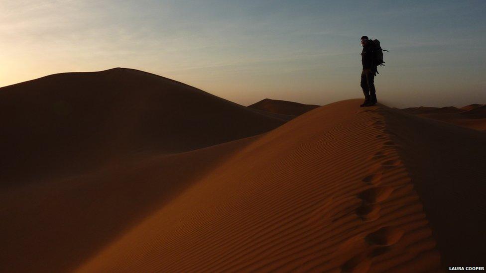 Man on sand dune in Morocco