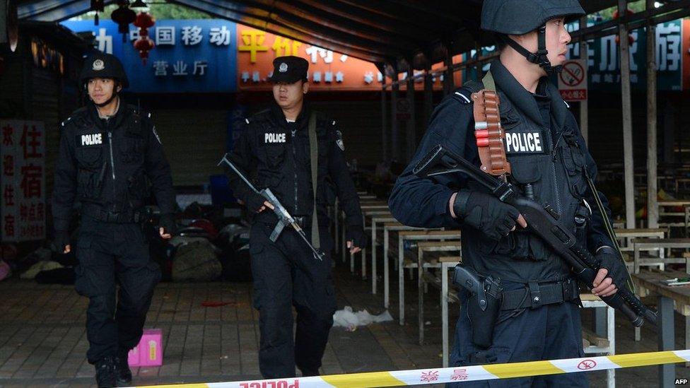 Chinese police stand guard at the scene of an attack at the main train station in Kunming, Yunnan province on 2 March 2014