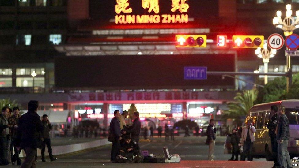 Chinese police investigators inspect the scene of an attack outside the railway station in Kunming, southwest China's Yunnan province, on 2 March 2014