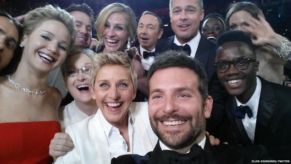 Ellen DeGeneres takes a picture with stars of the Oscars