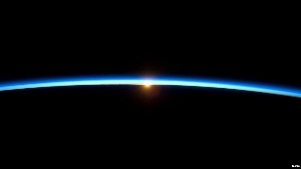 The sun setting over Earth.