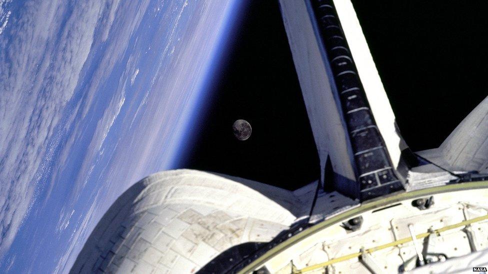 The Earth and Moon are nicely framed. This picture was taken from the aft windows of the Space Shuttle Discovery in 1998.