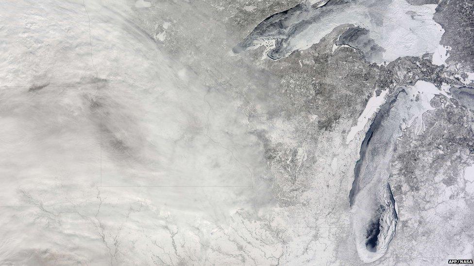 This March 3, 2014 NASA Terra satellite image shows snow cover along with ice covered lakes Superior (top) and Michigan.