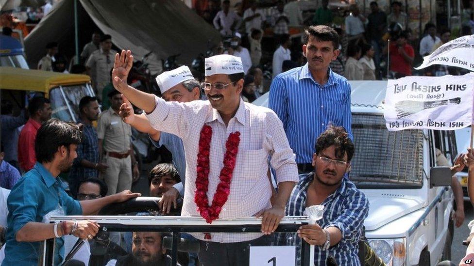 Leader of Aam Aadmi Party, or Common Man Party, and anti-corruption activist Arvind Kejriwal, center, greet supporters during an election rally in Ahmadabad.