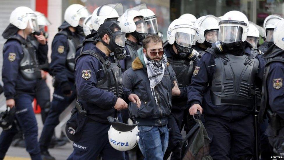 Riot police arrest a protester in Ankara (12 March 2014)