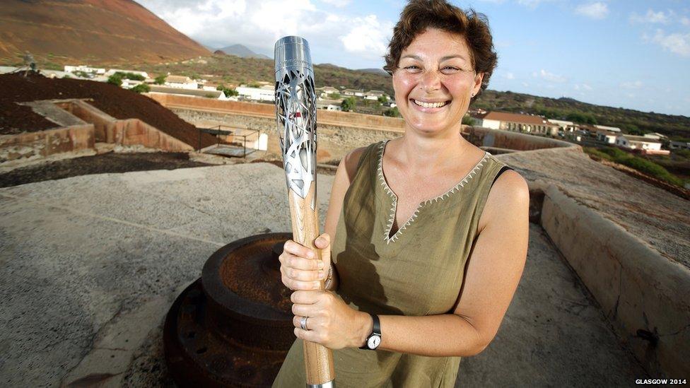 Ascension Heritage Society volunteer Helen Scott holds the Queen's Baton in Fort Hayes in Ascension Island