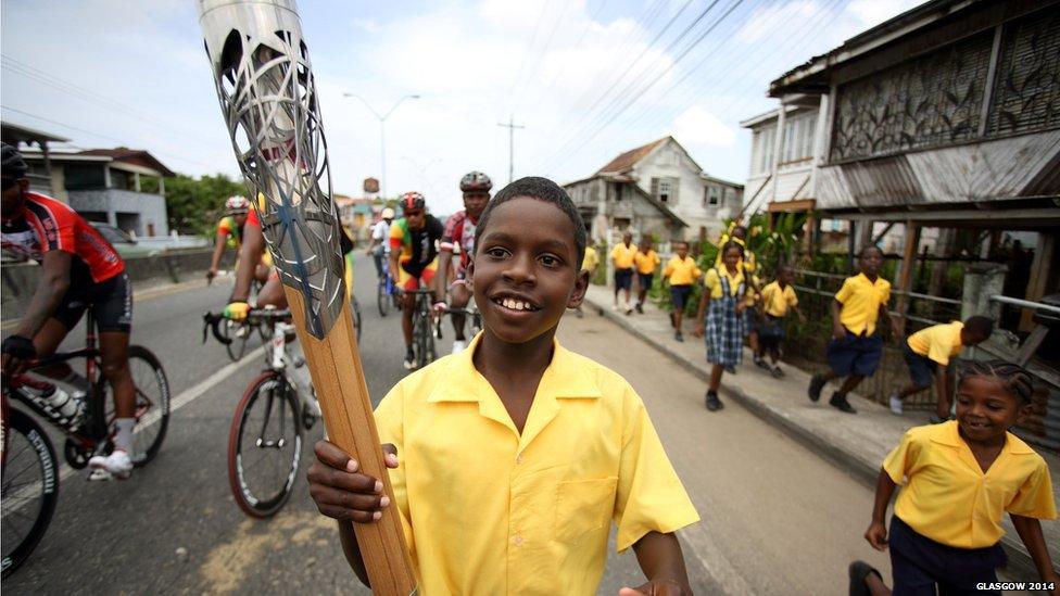 A student from Success Elementary School runs with the Queen's baton in Guyana.