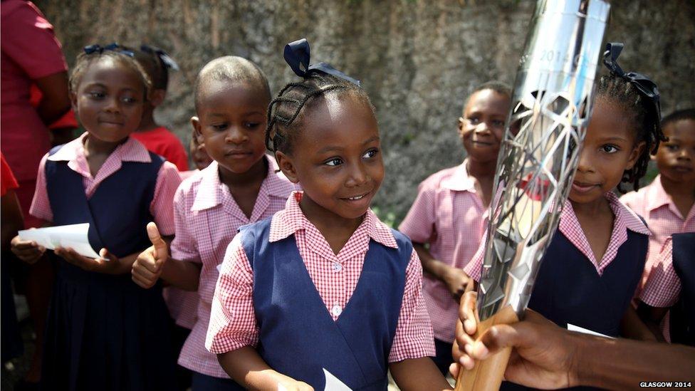 Students from Charles F Broome Primary School reach out to touch the Queen's Baton in Barbados.