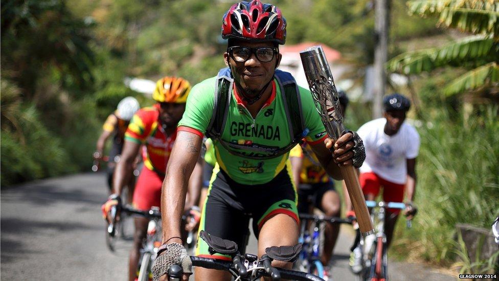 Cyclist Tessimy Viechweg rides with the Queen's baton in Grenada.