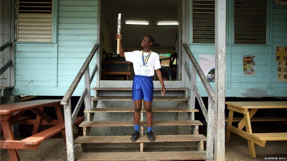 Sprinter Joy Edwards holds the Queen's Baton at Fond Assau Combined School in Castries, Saint Lucia.