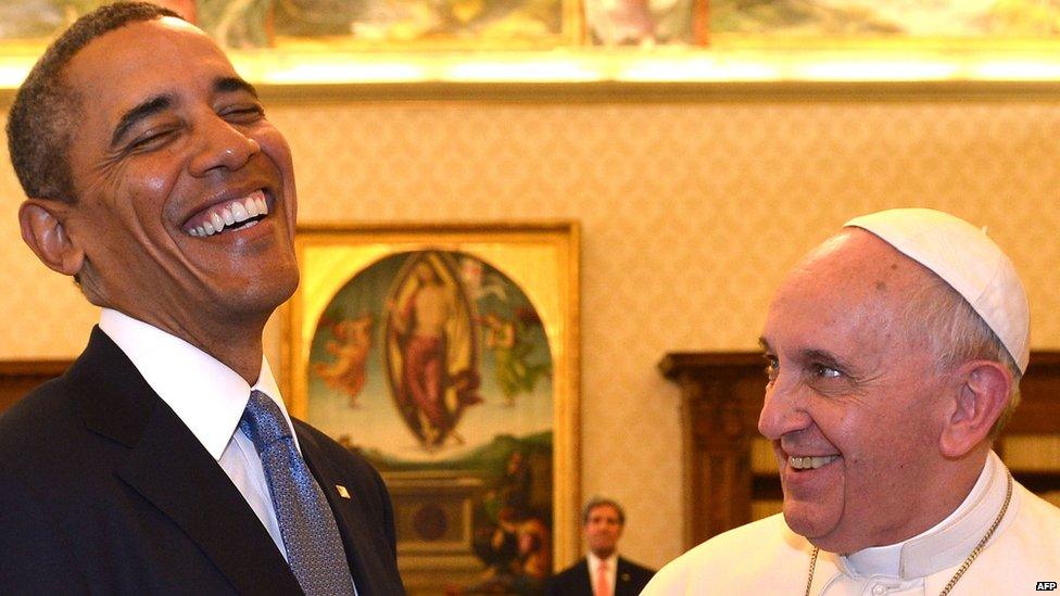 Pope Francis and US President Barack Obama laugh as they exchange gifts