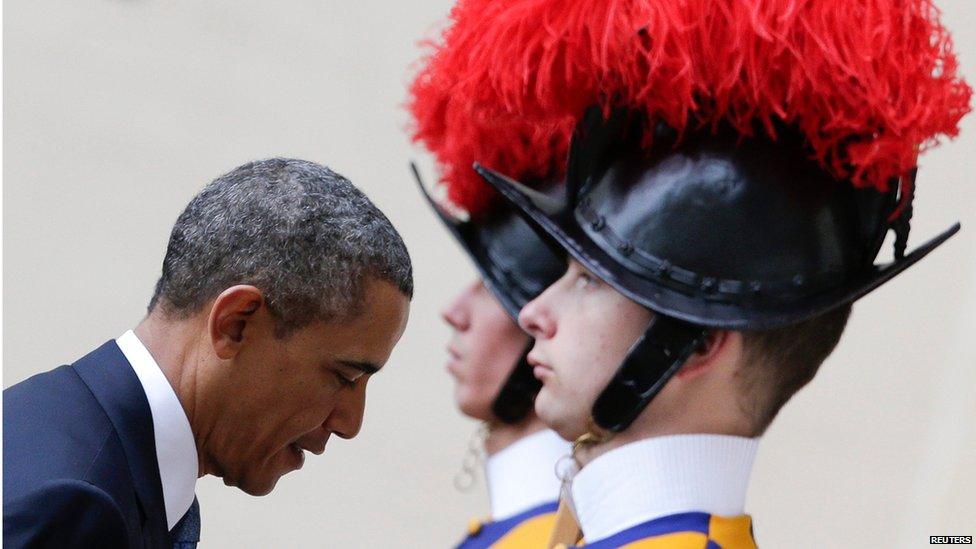 US President Barack Obama passes members of the Swiss Guard as he arrives at the Vatican for a private audience with Pope Francis