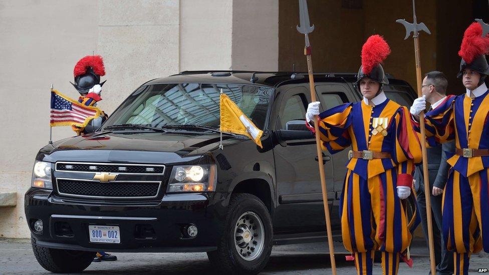 The car of US President Barack Obama enters the Vatican prior a private audience with Pope Francis, flanked by members of the Swiss Guard